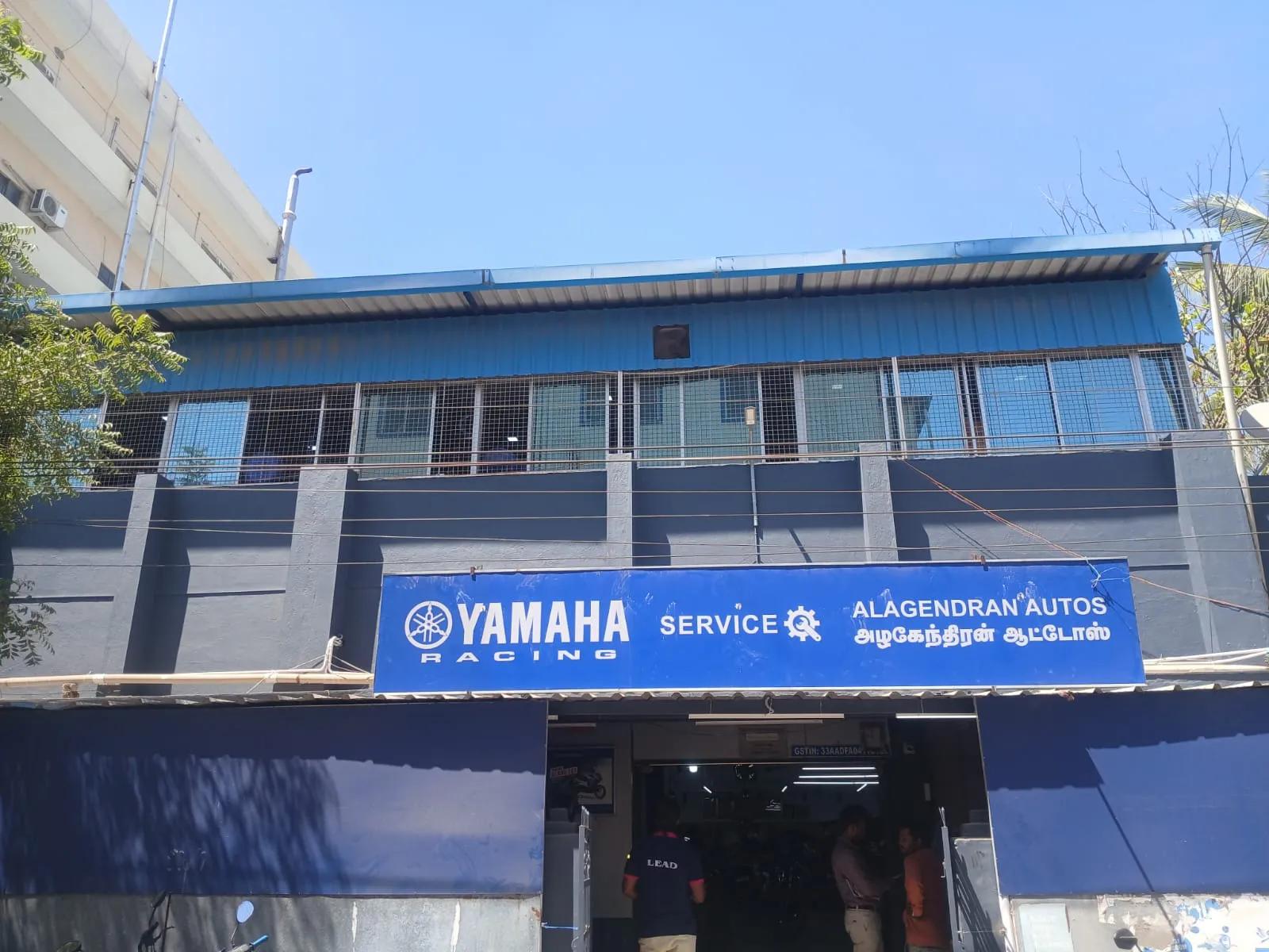 Alagendran Autos building in Madurai with a blue Yamaha Service signboard in English and Tamil