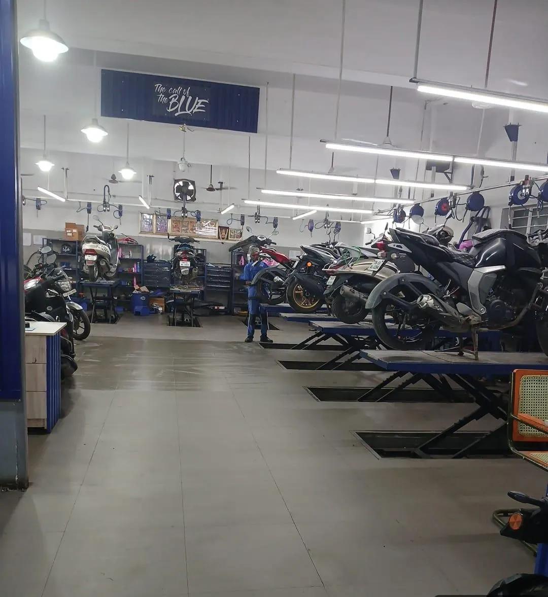 Yamaha motorcycles and scooters on service bays inside the Alagendran Autos workshop